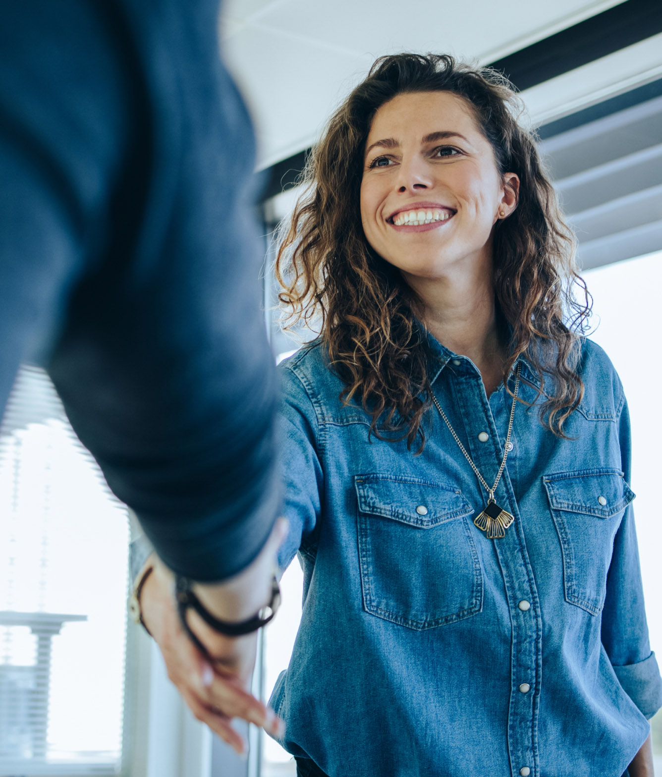 Woman in Jean Shirt Shaking Hands